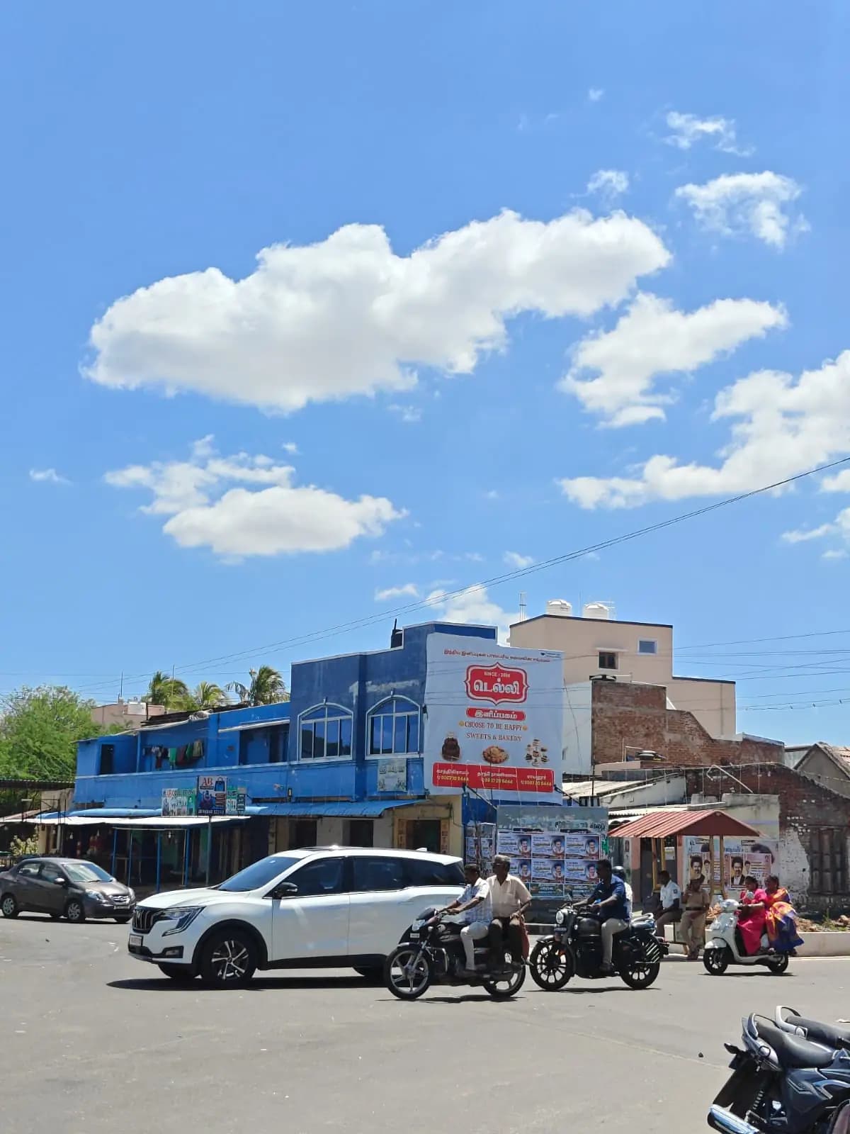 Rooftop bakery hoarding on corner building, wide street view