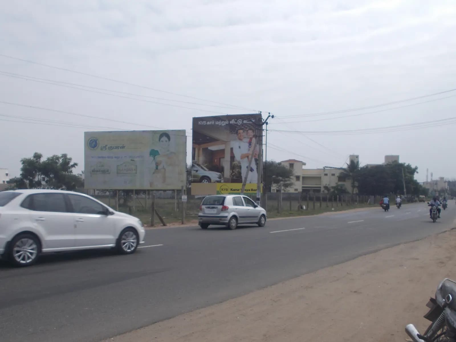 Two roadside hoardings facing an arterial road