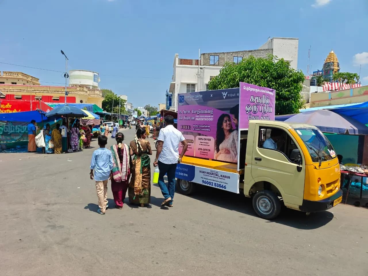 Mini-truck mobile ad van with flex banners on street