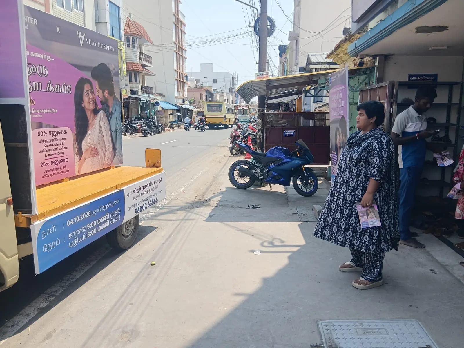 Campaign van with poster panels parked on busy street