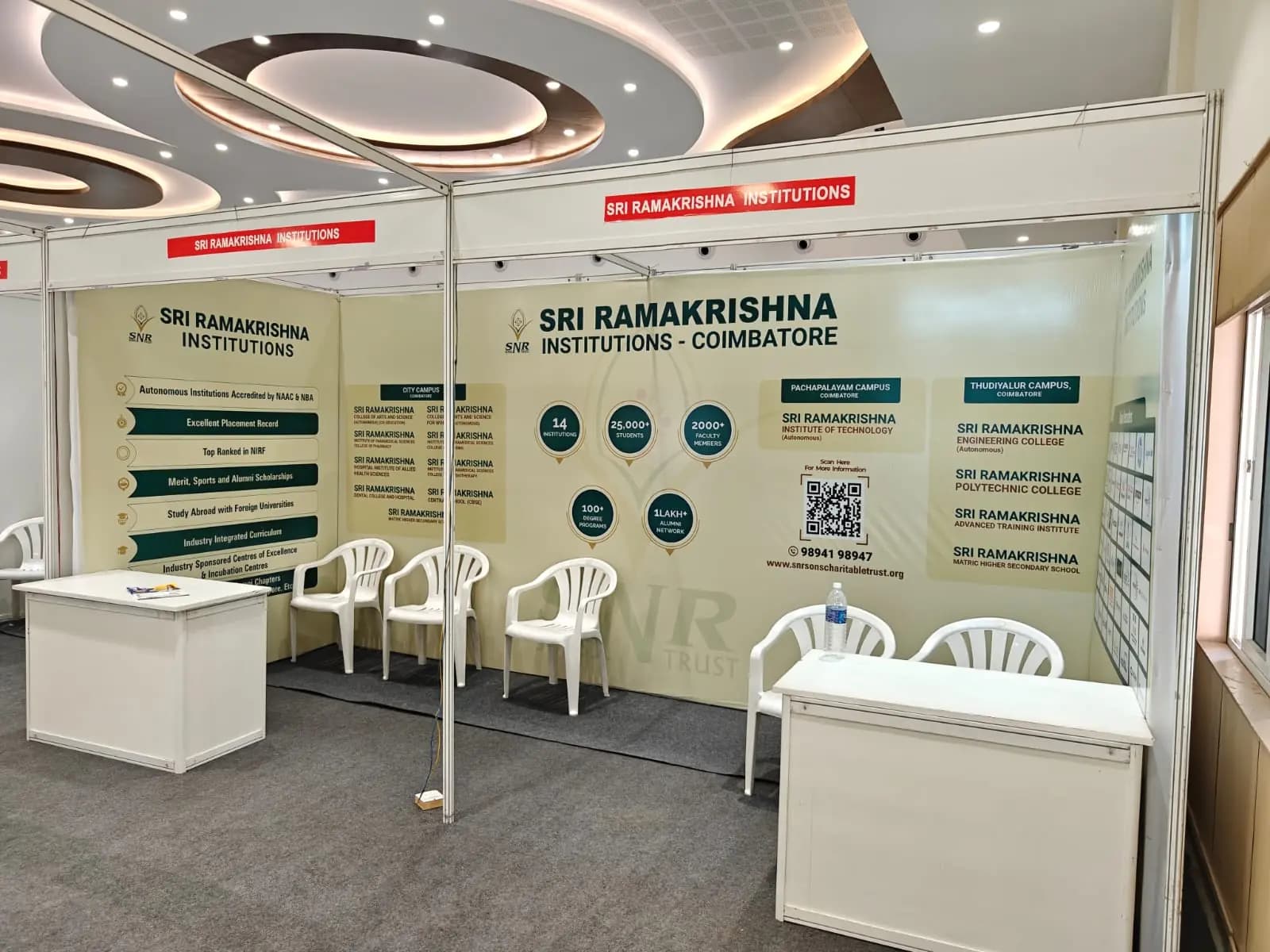 Expo stall with branded panels, desks and chairs