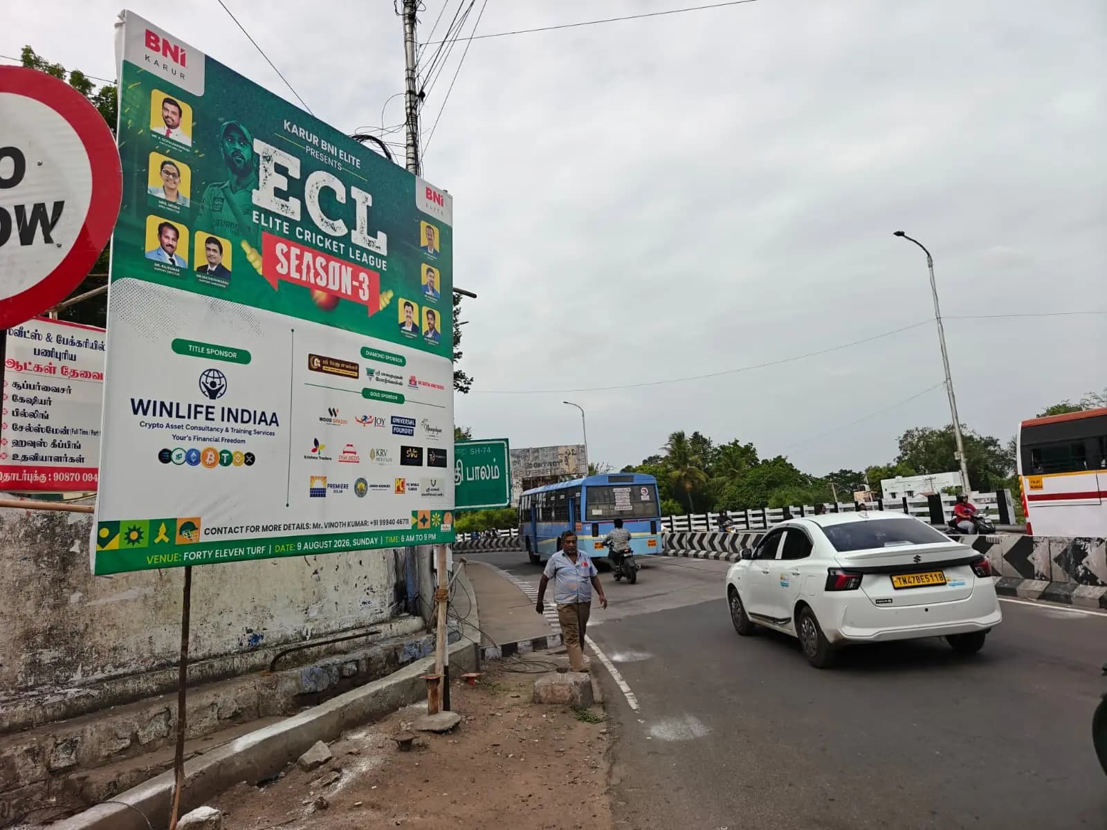 ECL Season 3 roadside boards beside busy road