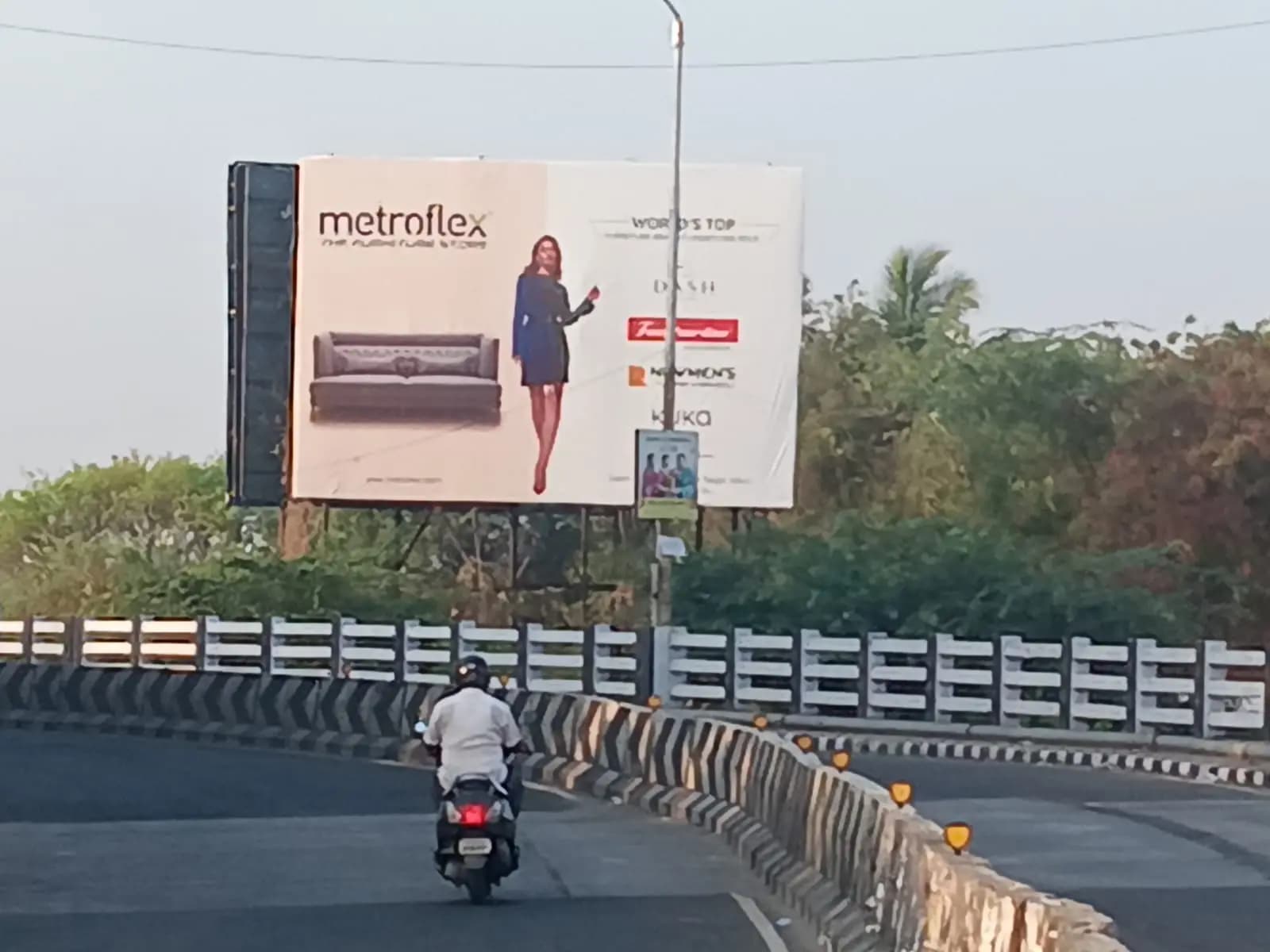 Metroflex sofa hoarding beside flyover road