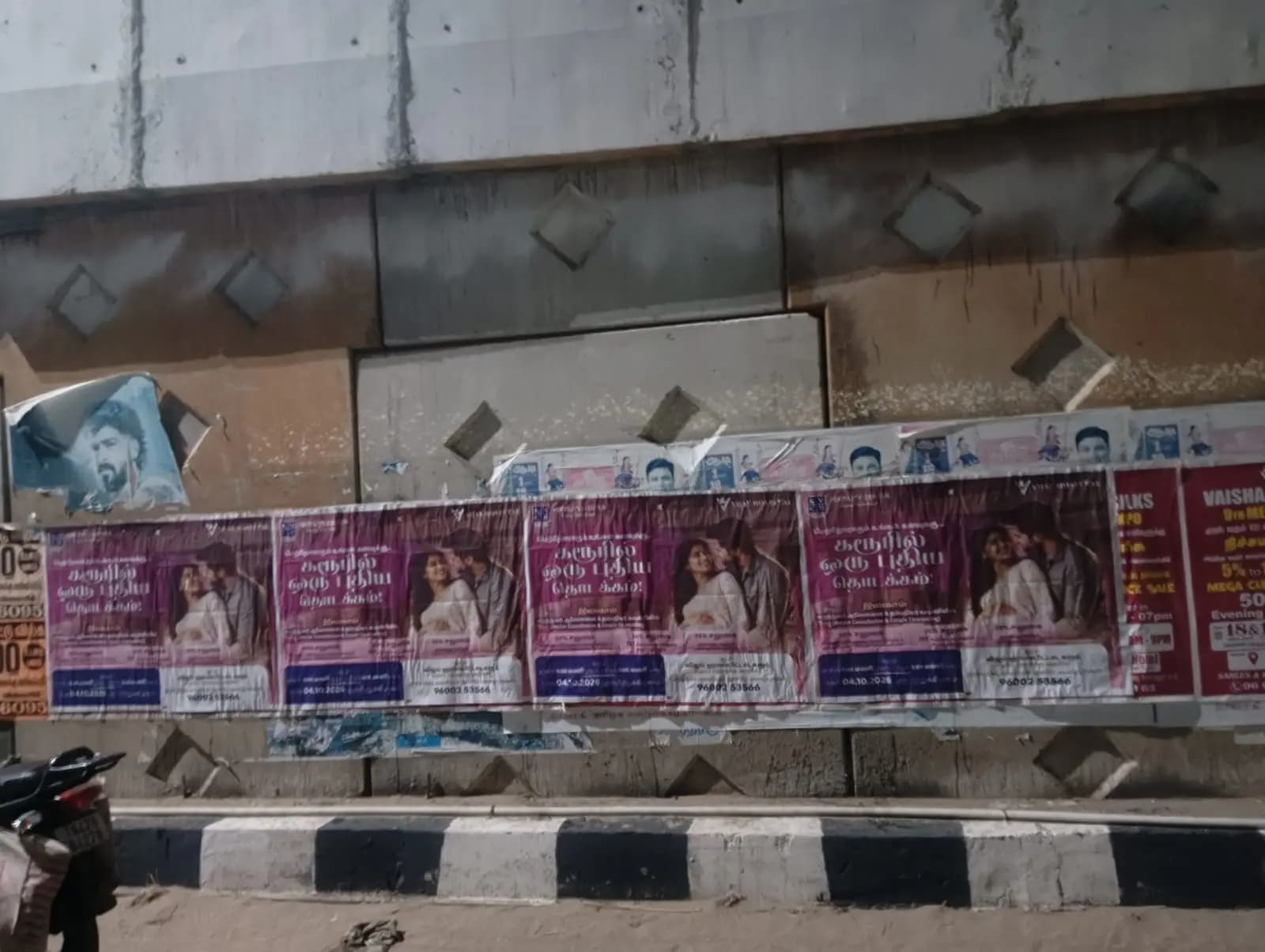 Row of purple posters along underpass wall
