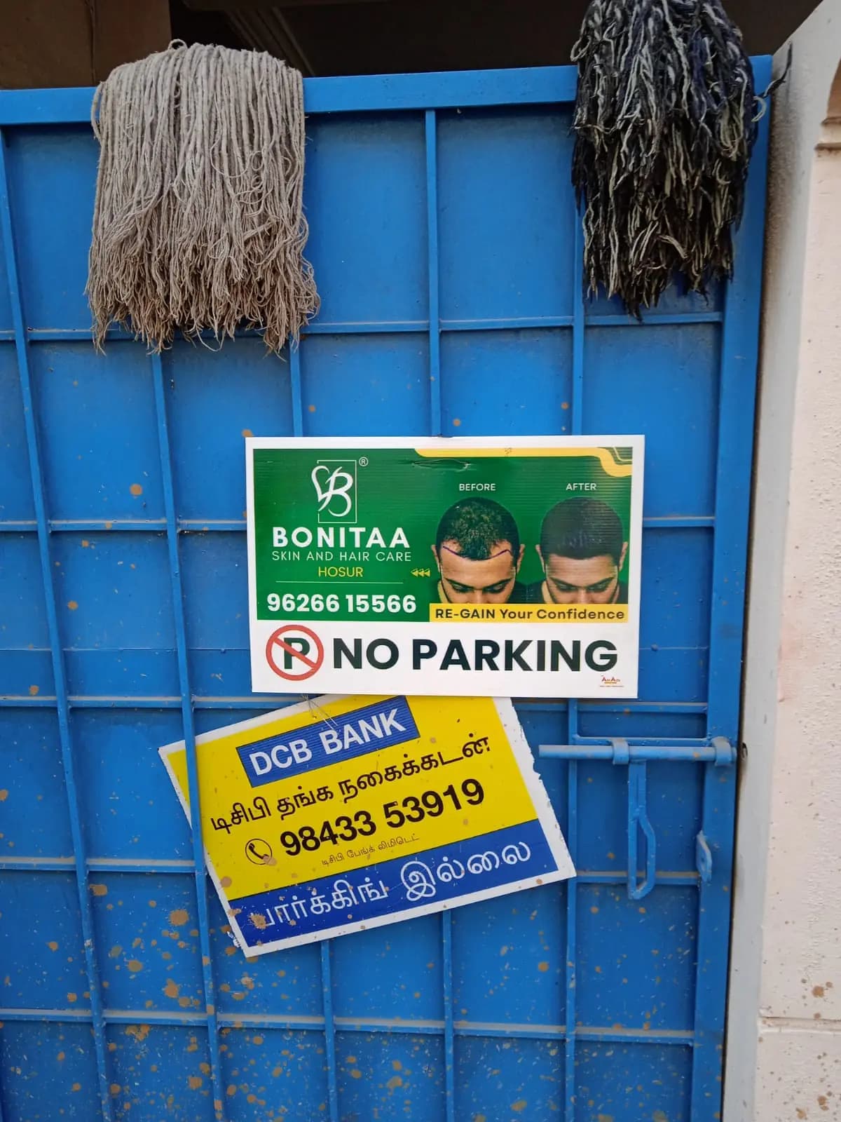 Bonitaa No Parking board and DCB Bank sign on gate
