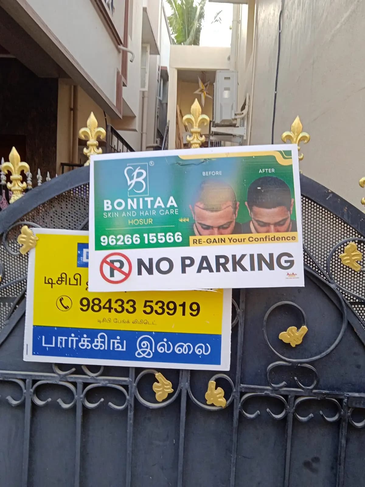 Sponsored 'No Parking' board on house gate