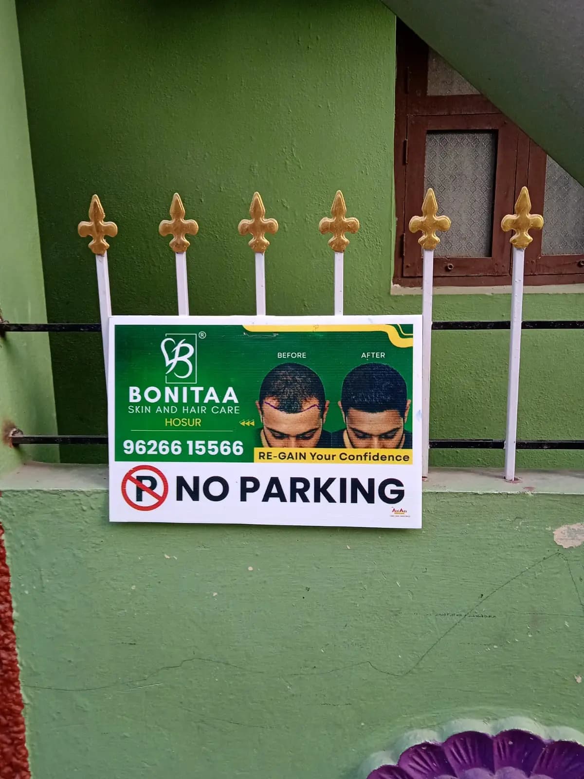 Sponsored 'No Parking' board on house gate