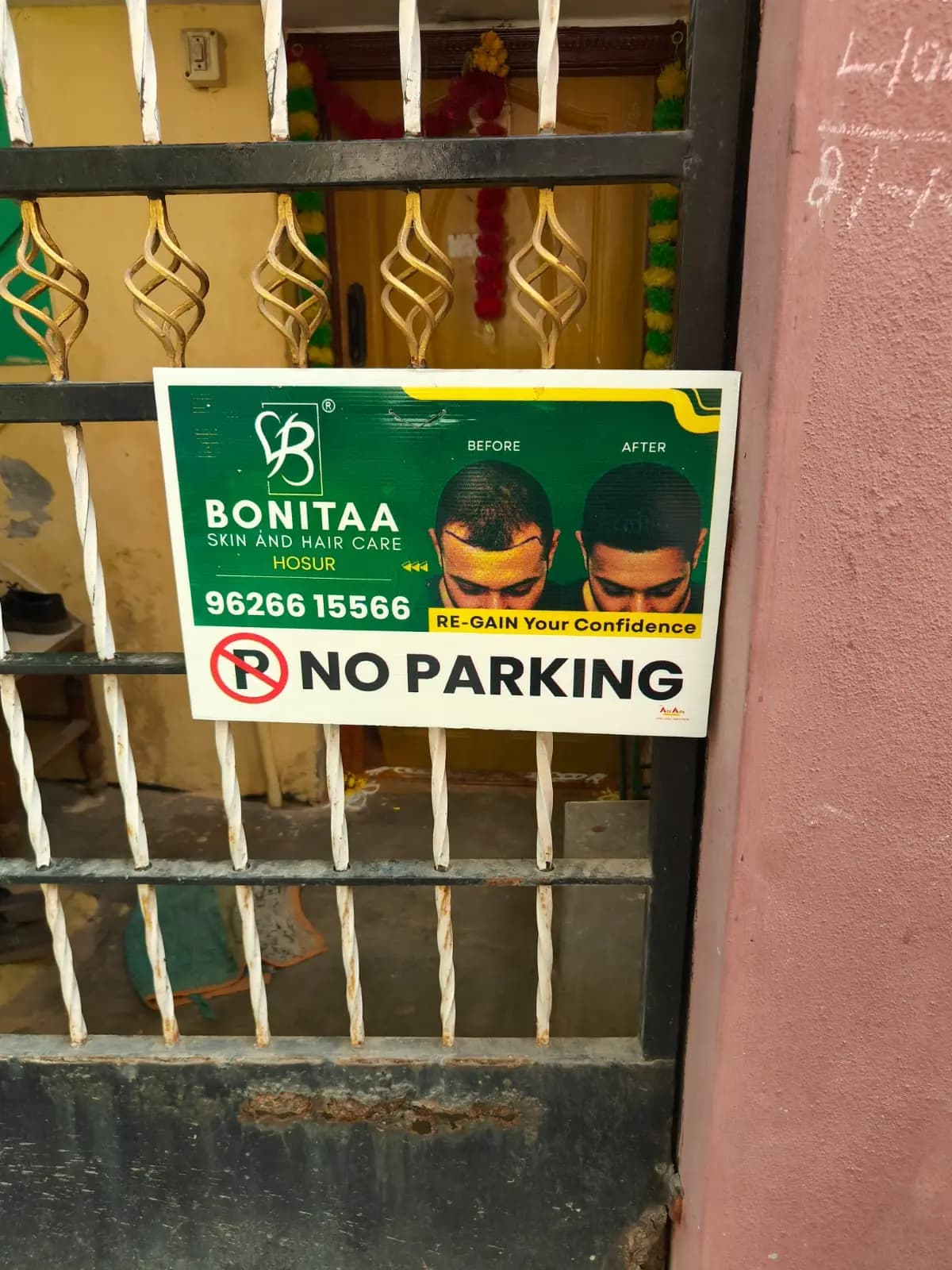 Sponsored No Parking board on house gate